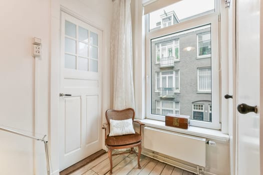 a small room with a chair and a window