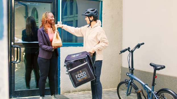 Food delivery courier delivering restaurant meal in package