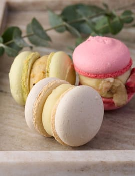 Baked macarons with different flavors on the table, dessert