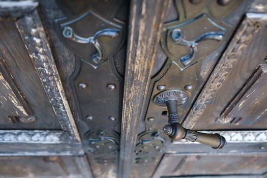 Old metal door handle on the old door