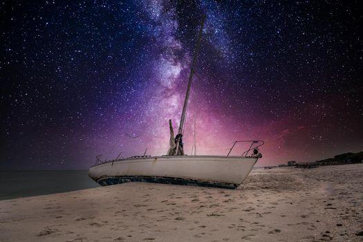 Milky way in the night sky over a shipwreck off the coast of Clam Pass