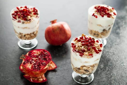 Raw healthy dessert from yoghurt, muesli and pomegranate