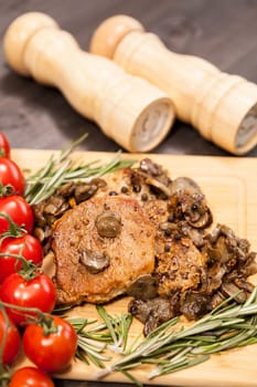 Close up top view on pork steak with grilled mushrooms