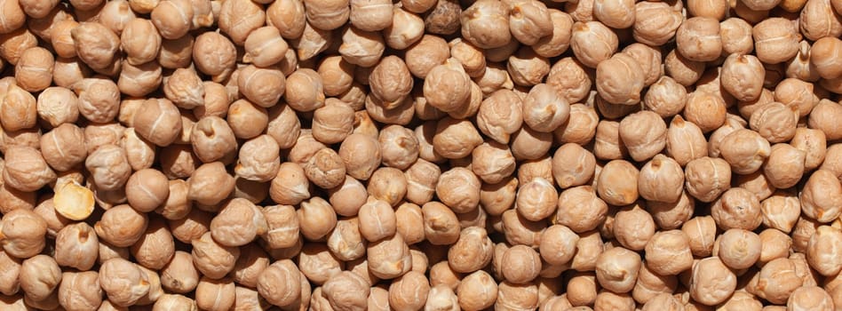 Raw chickpea beans. Top view on chickpea seeds. Food background from a texture of raw chickpeas close-up, top view. Uncooked chickpea. healthy food banner.