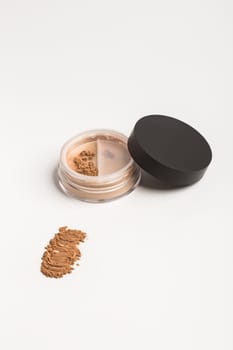 Bronzer or brown eye shadow mineral face powder twist seal sifter. Facial powder isolated on white background