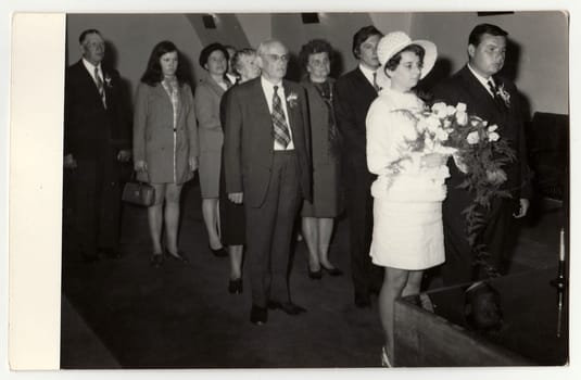 A vintage photo shows wedding ceremony, circa 1970.