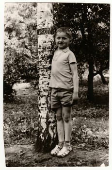 Vintage photo of a young boy (about 13 years old) in nature.
