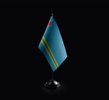 Small national flag of the Aruba on a black background