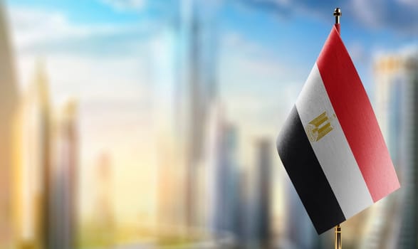 Small flags of the Egypt on an abstract blurry background