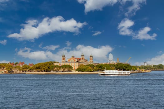 Blue sky with white clouds over Ellis Island and Ellis Island Hospital