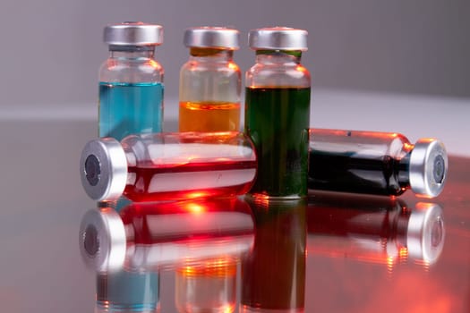 Collection of drug vials with colored solution.