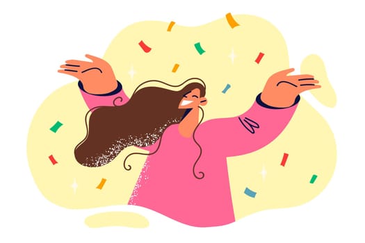 Positive woman raising hands rejoicing with festive confetti during birthday or christmas party