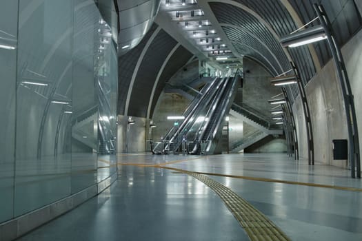 Futuristic subway station with guiding lines and an escalator near Heumarkt in Cologne, Germany
