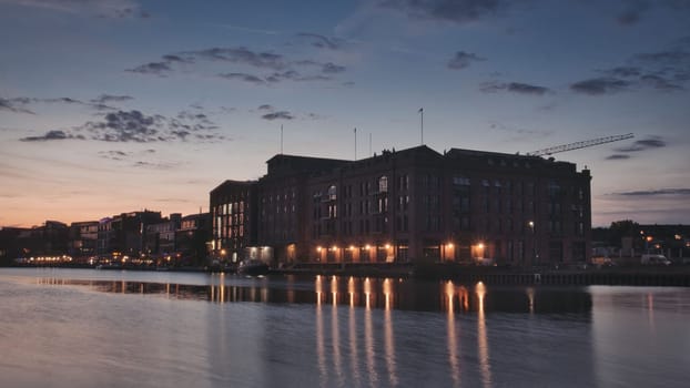 Old brick building illuminated at sunset in the harbor of Munster, Germany