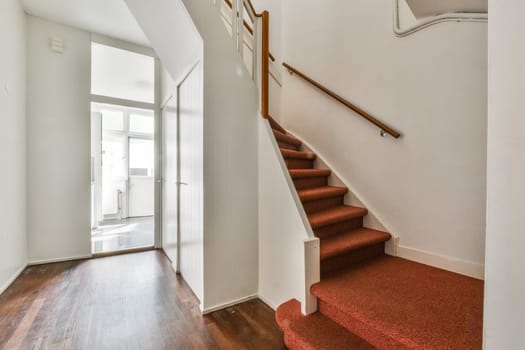 a stairway in a home with red carpeting