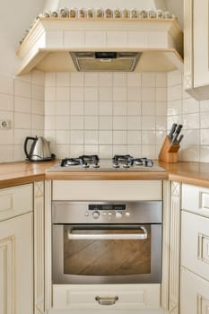 a white kitchen with a stainless steel stove and oven