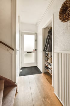 a hallway with a door to a closet and stairs