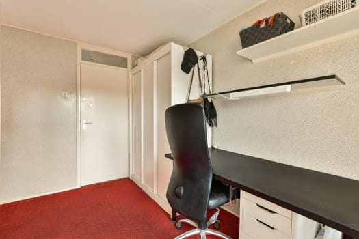 a room with a desk and a chair in it