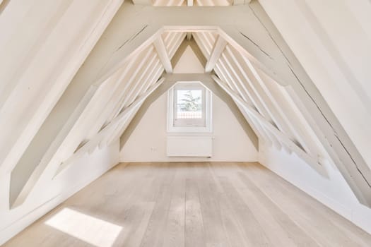 the attic of a house with a window and white