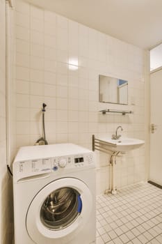 a white laundry room with a washing machine in it