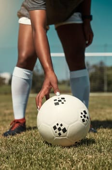 Hand, placing and soccer ball on field for free kick, penalty or goal in game, training or match. Woman, football and grass outdoor in summer for fitness, exercise and workout in sports for wellness