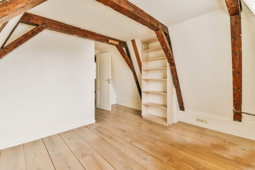 a white room with wooden floors and exposed beams
