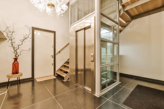 a lobby with a staircase and a glass door