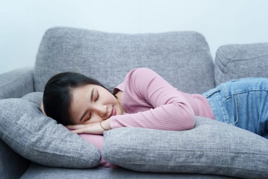Portrait of a beautiful Asian teen girl relaxing on the sofa at home