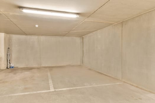 an empty room with concrete walls and a fluorescent light