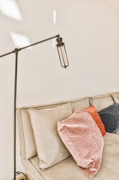 a couch with pillows and a lamp on top