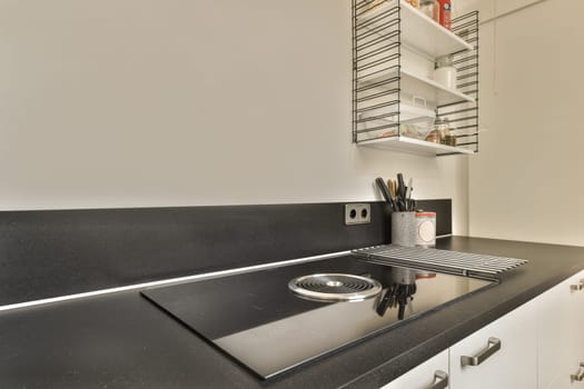 a kitchen counter with a sink and a stove top