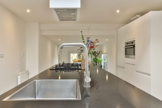 a kitchen with a large sink and a large counter