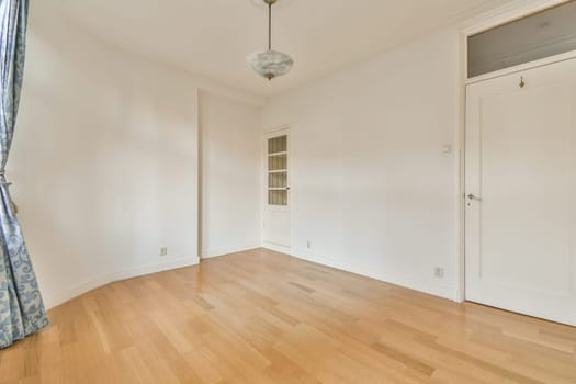 a living room with white walls and a wooden floor