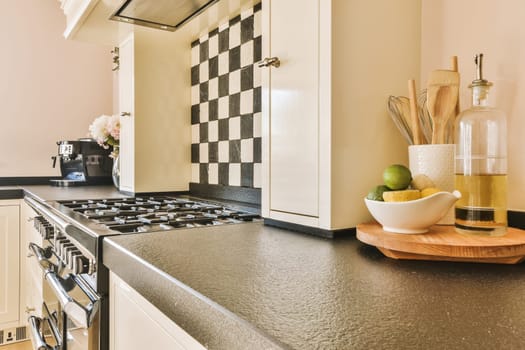 a black counter top in a kitchen with a stove