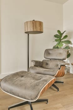 a living room with a chair and a lamp