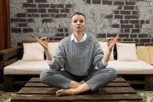 successful female freelancer doing yoga in a cozy atmosphere