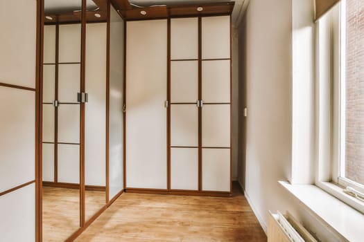 a walk in wardrobe in a room with a window