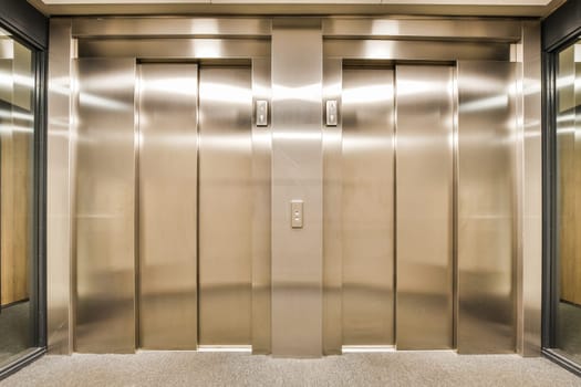 a row of stainless steel elevator doors in a building