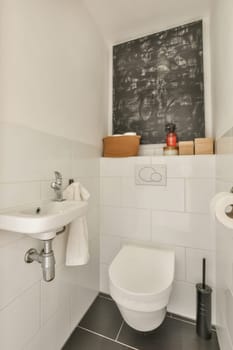 Amsterdam, Netherlands - 10 April, 2021: a bathroom with a chalk board on the wall behind it and a toilet in the corner next to the sink