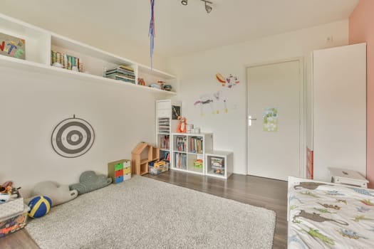 a childrens room with a rug and a shelf