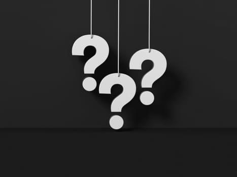 Room black wall background with Three question marks white hanging.