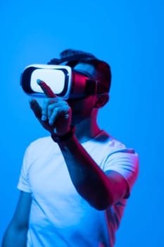 Man wearing virtual vr goggles. Young bearded man wearing virtual reality headset. VR concept.