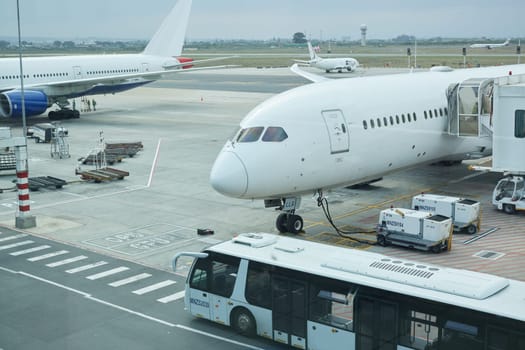 Airplane, bus and loading luggage outdoors for travel with heat pump for air conditioning for ac ventilation on journey. Global, transportation or commercial aeroplane on ground with cargo for flight.