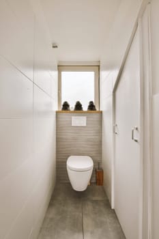 a small bathroom with a toilet and a window