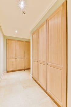 a large closet with wood cabinets and a tile floor