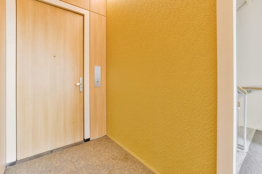 a wooden door with a yellow wall in a room
