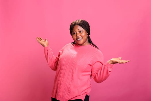 Silly funky woman expressing surprised reaction and having fun in studio