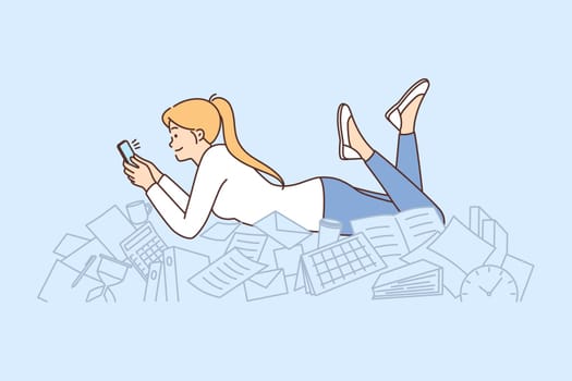 Procrastination woman with phone lies on documents and stationery oblivious to mess
