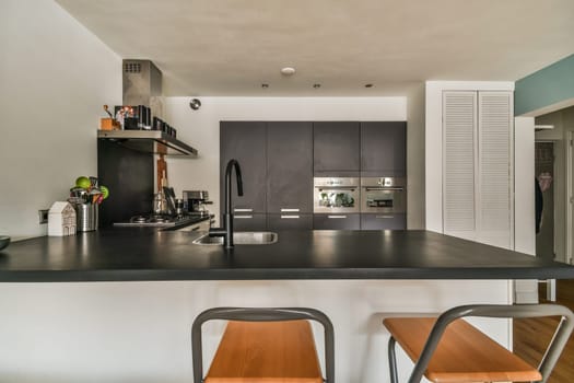 a kitchen with a counter top and two stools