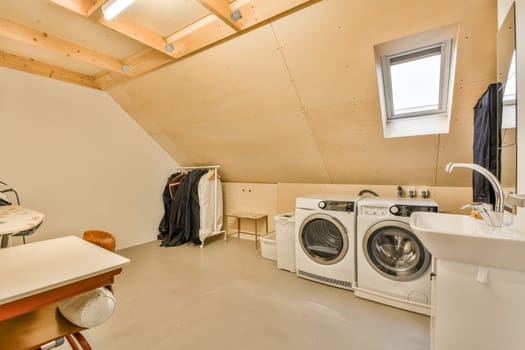 a laundry room with a washing machine and a sink